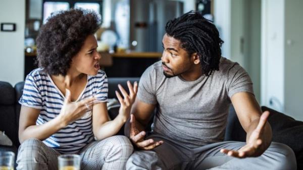 Jealous woman sitting on sofa holding phone feeling sad waiting for call, frustrated millennial girl upset or worried receiving bad news in mobile message on smartphone at home, cyberbullying concept