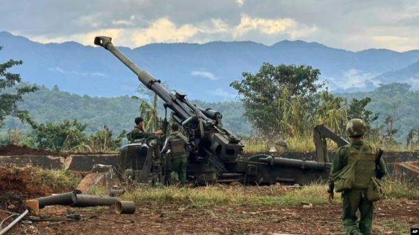 Members of an ethnic armed forces group, one of the three militias known as the Three Brotherhood Alliance, check weapons the group said it seized from Myanmar's army outpost in Hsenwi, Nov. 24, 2023. (Kokang o<em></em>nline media via AP)