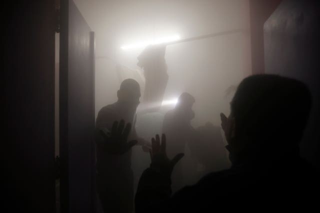 Palestinian paramedics inspect damage in patient rooms caused by Israeli strikes on the maternity ward at Nasser Hospital in the town of Khan Younis, southern Gaza Strip, on Sunday