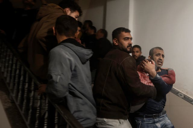 Palestinians evacuate a wounded boy following Israeli strikes on the maternity ward at Nasser Hospital in the town of Khan Younis, southern Gaza Strip, on Sunday 