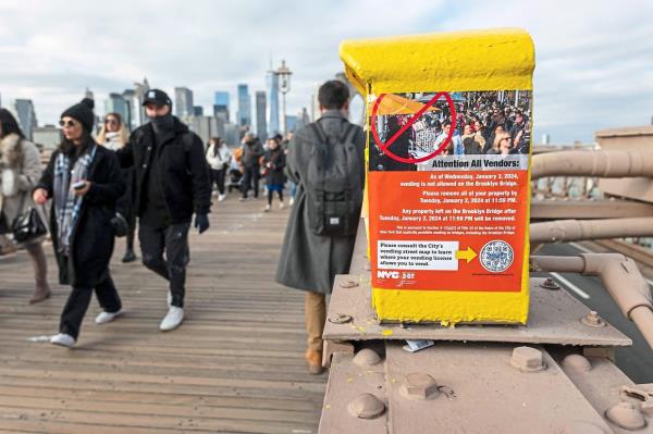 A sign a<em></em>lerting vendors of a new law banning vendors on the bridge in New York City. — AFP