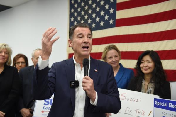 Tom Suozzi speaking into a microphone while opening a new campaign office in Great Neck for his co<em></em>ngressional run on January 14th, 2024.